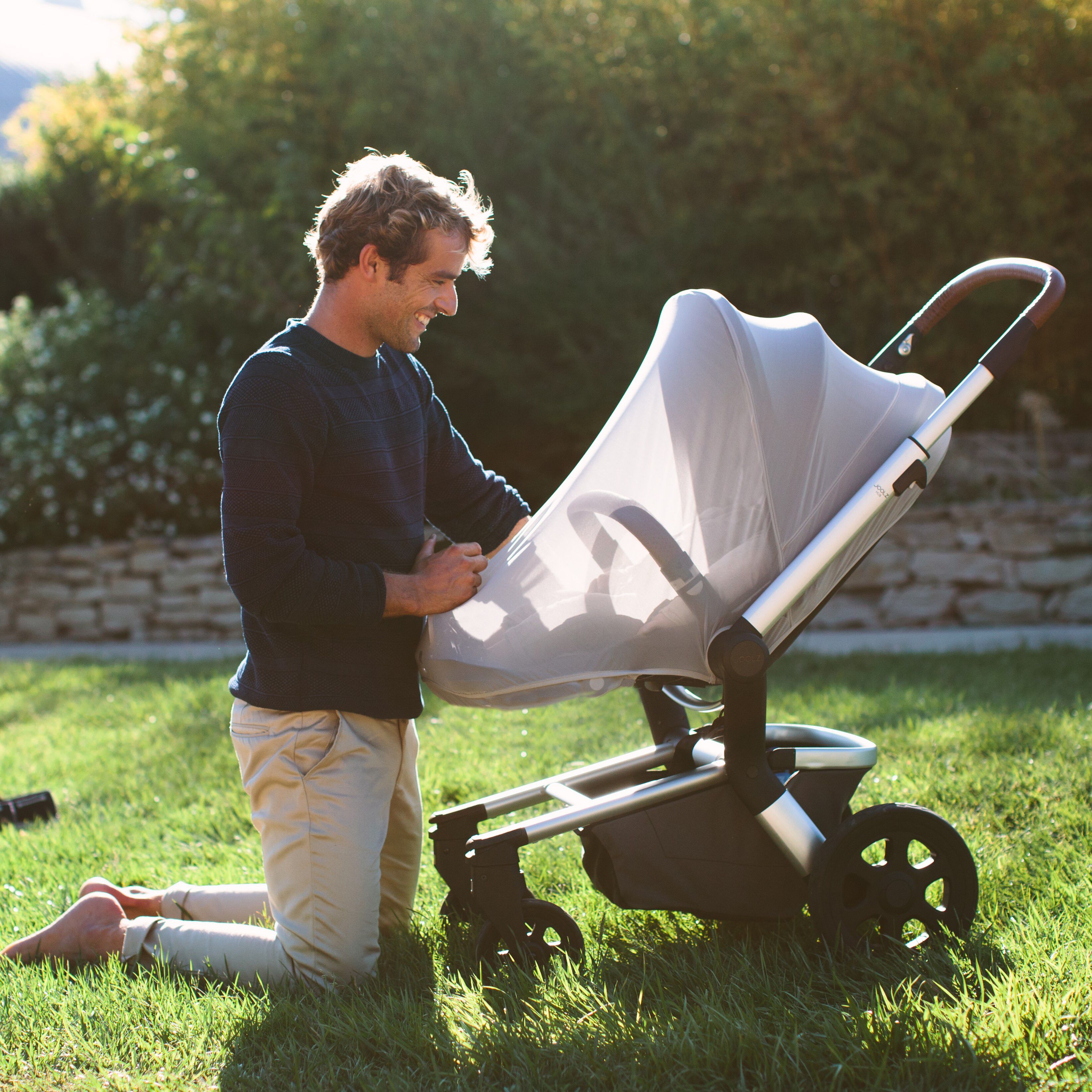 Father looking at child through the mosquito net